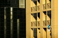 Painter painting on high rise building