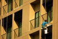 Painter painting on high rise building