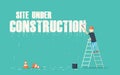 Painter painting the word site under construction on a wall. Royalty Free Stock Photo