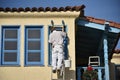 Painter, Painting a yellow and blue trimmed house