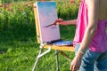 The painter paints oil paintings in the garden at sunset Royalty Free Stock Photo