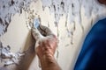 Painter preparing a wall for painting, featuring activities such as sanding, filling cracks, and applying primer, highlighting the