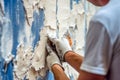 Painter preparing a wall for painting, featuring activities such as sanding, filling cracks, and applying primer, highlighting the