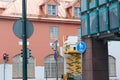 Painter with roller painting house facade in town Royalty Free Stock Photo