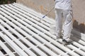 Painter Rolling White Paint Onto Top of Patio Cover Royalty Free Stock Photo