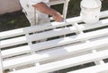 Painter Rolling White Paint Onto Top of Patio Cover Royalty Free Stock Photo
