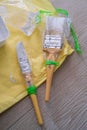 Painter's brush wrapped in plastic to prevent from drying up. Reusable for next project