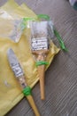 Painter`s brush wrapped in plastic to prevent from drying up. Reusable for next project