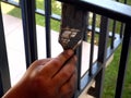 painter`s hand with brush painting steel corridor railing. selective focus. Royalty Free Stock Photo