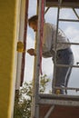 Painter on scaffold