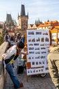 Painter selling pictures on Charles Bridge in Prague