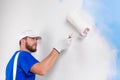 Painter in white dungarees, blue t-shirt Royalty Free Stock Photo