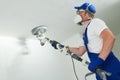 Painter work with ceiling. polishing and sanding the surface after putty for painting Royalty Free Stock Photo