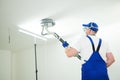 Painter work with ceiling. polishing and sanding the surface after putty for painting Royalty Free Stock Photo