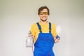 Painter in work clothes with a paint spray gun Royalty Free Stock Photo