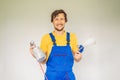 Painter in work clothes with a paint spray gun Royalty Free Stock Photo