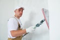 Painter work angle sander. sanding the wall corner surface after putty for painting