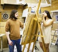 Painter at work with model muse in studio waiting inspiration, l Royalty Free Stock Photo