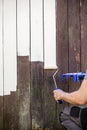Painter at work, old weathered backyard shed will be chalk and p Royalty Free Stock Photo