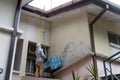 Painter worker adding undercoat foundation paint onto wall with roller at residential building in renovation Royalty Free Stock Photo