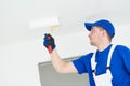 Painter painting ceiling with paint roller Royalty Free Stock Photo