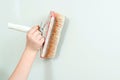 Painter worker is painting a wall with brush. Hand holding brush painting white color. Home renovations service Royalty Free Stock Photo