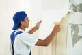 Painter worker peeling off wallpaper Royalty Free Stock Photo