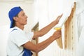 Painter worker peeling off wallpaper Royalty Free Stock Photo