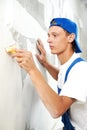 Painter worker peeling off wallpaper Royalty Free Stock Photo