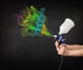 Painter working with airbrush and paints colorful paint Royalty Free Stock Photo