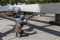 The painter is working to fireproof paint on steel structure with spray gun