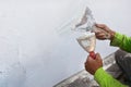Painter's hand puttied wall using A paint trowel. Royalty Free Stock Photo