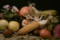 Painterly still-life with raw vegetables, fruits and flowers