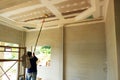 Painters are painting the ceiling of a new home