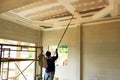 Painters are painting the ceiling of a new home