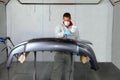 Painters use spray guns to apply paint to a bumper.