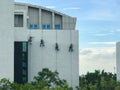 Painters hanging on roll at building wall