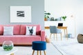 Painting above pink sofa with pillows in open space interior wit Royalty Free Stock Photo