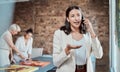 Painting, artistic and call with a woman art gallery manager talking on a phone in a studio with her team in the Royalty Free Stock Photo