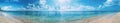 A Painting of a Beach With Blue Water and Clouds Royalty Free Stock Photo
