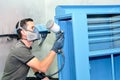 Painting a blue steel vintage dentist cabinet. Real worker, no model Royalty Free Stock Photo