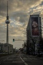 Painting in a building with a black girl smiling and the Fernsehturm on the left side. Berlin, Germany