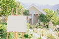 Painting canvas on wood stand outdoor with blur green nature house mountain view background Royalty Free Stock Photo