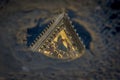 Painting on Cattedrale Metropolitana di Santa Maria Assunta in Siena seen as a reflection in a rain pool