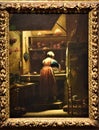 Painting, depicting a housewife, who is washing the dishes from behind, in an ancient kitchen, at the Uffizi museum in Florence.