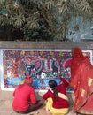 Painting doing artists on road bondry wall in madhubani India