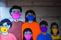 A painting done on a wall to create awareness about corona .it tells us to wear mask and be safe . the whole family is wearing