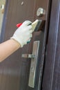 Painting door, painting a metal door to the house with a brush and hand Royalty Free Stock Photo