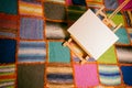 Painting easel in front of a colorful quilt