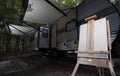 Painting easel in front of a camping trailer